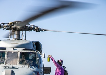 USS Mitscher (DDG 57) presents fuel sample to HSM 79 Sea Hawk during flight quarters