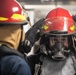 USS Mitscher (DDG 57) Sailor dons firefighting gear during GQ drill