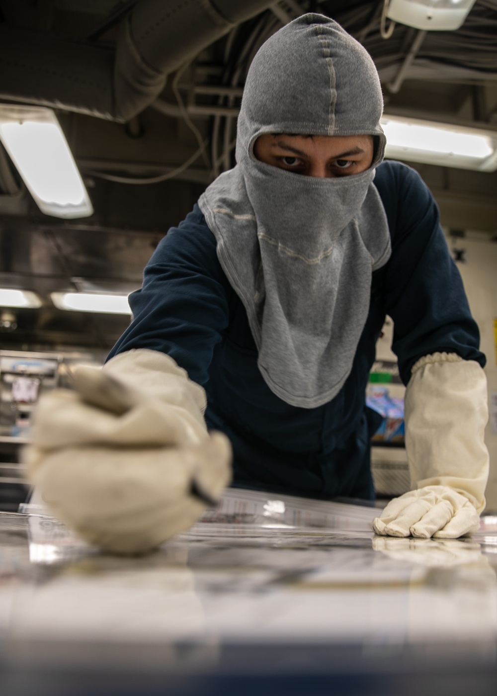 USS Mitscher (DDG 57) junior officer marks damage control fittings during GQ