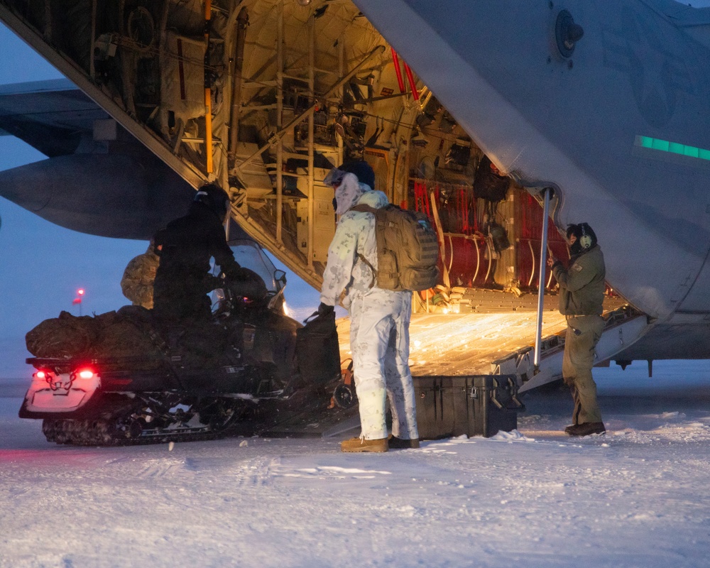 U.S. Marines offload gear from KC-130 after completing Toys for Tots mission.