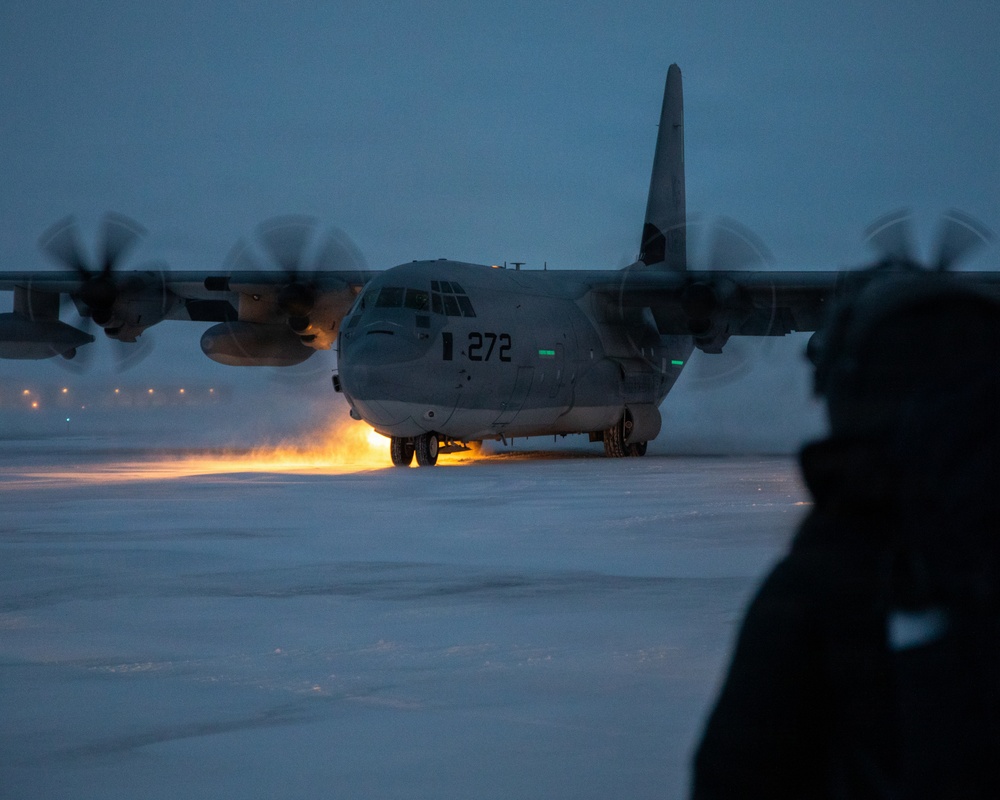 U.S. Marines offload gear from KC-130 after completing Toys for Tots mission.
