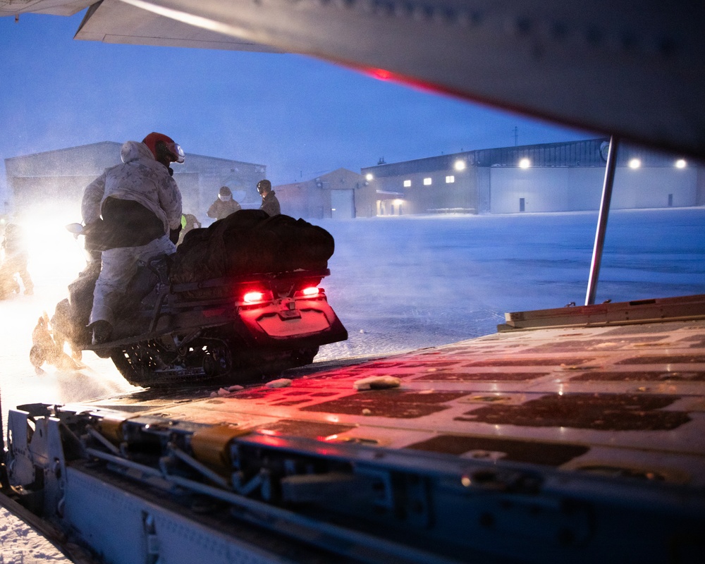U.S. Marines offload gear from KC-130 after completing Toys for Tots mission.