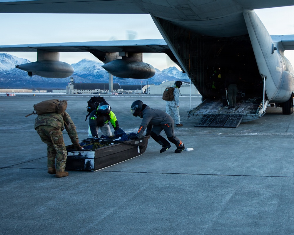 U.S. Marines offload gear from KC-130 after completing Toys for Tots mission.