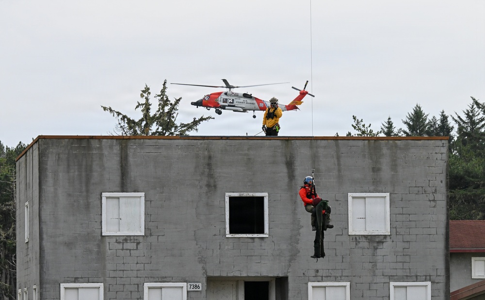 U.S. Coast Guard MH-60 Jayhawk and MH-65 Dolphin helicopter aircrews train as part of Advanced Helicopter Rescue School at the Camp Rilea Armed Forces Training Center in Oregon.