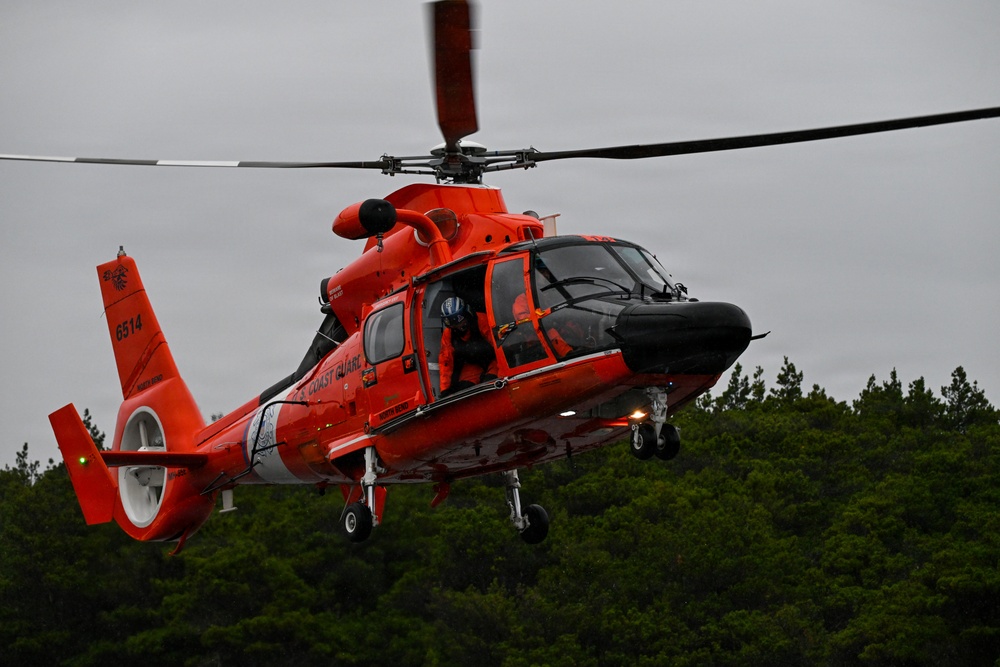 U.S. Coast Guard aviation survival technicians train as part of Advanced Helicopter Rescue School in Fort Stevens State Park, Oregon