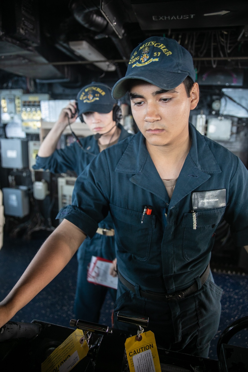 USS Mitscher (DDG 57) Sailor mans helm in ship bridge