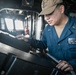 USS Mitscher (DDG 57) junior officer views navigation monitor in ship bridge