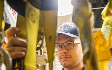 USS Mitscher (DDG 57) Sailor inspects safety harnesses in ship ET shop