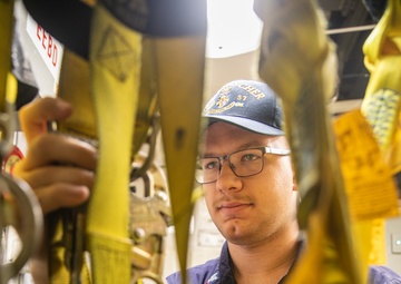 USS Mitscher (DDG 57) Sailor inspects safety harnesses in ship ET shop