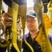 USS Mitscher (DDG 57) Sailor inspects safety harnesses in ship ET shop