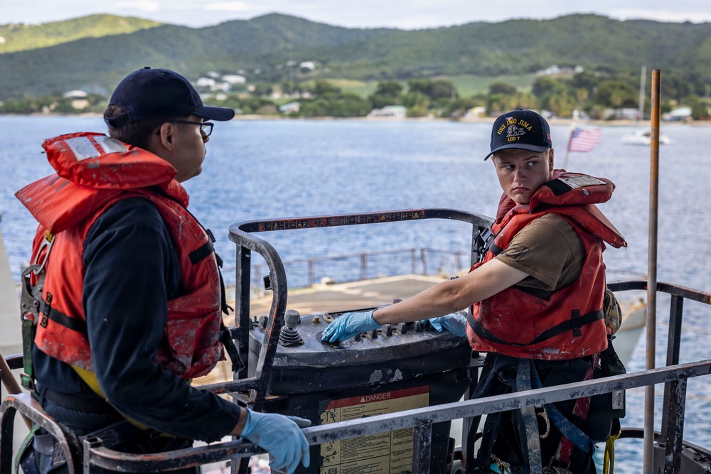 USS Iwo Jima Sailors Painting The Hull