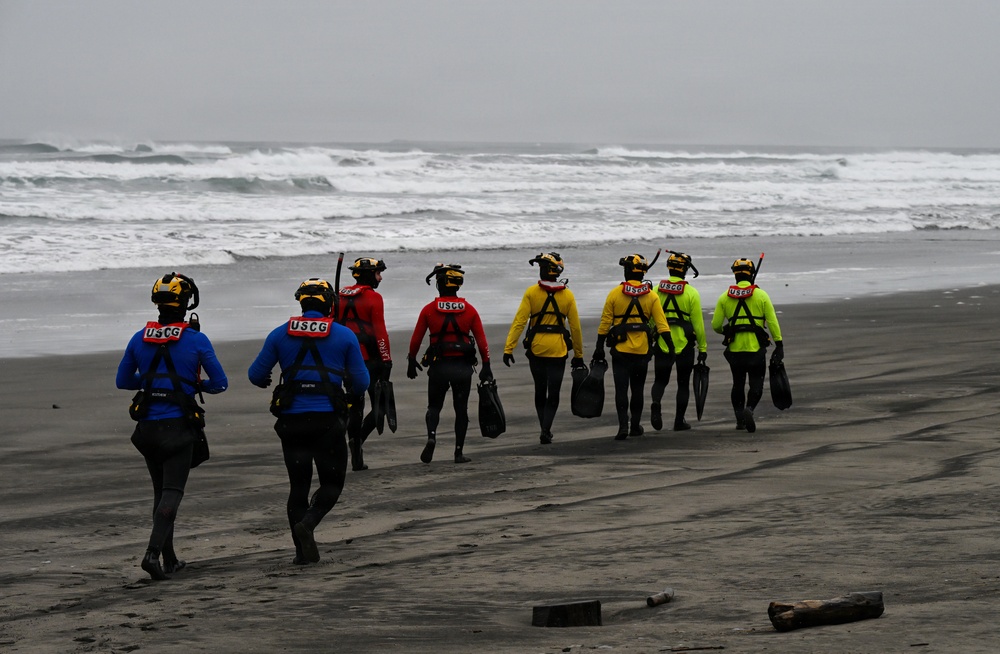U.S. Coast Guard aviation survival technicians train as part of Advanced Helicopter Rescue School in Fort Stevens State Park, Oregon