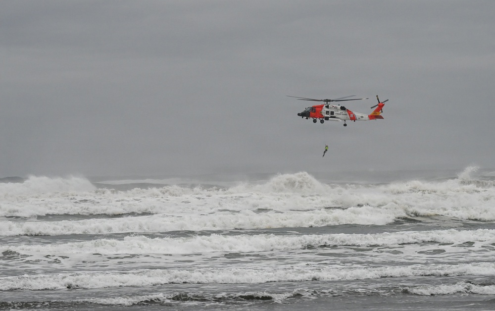 U.S. Coast Guard aviation survival technicians train as part of Advanced Helicopter Rescue School in Fort Stevens State Park, Oregon
