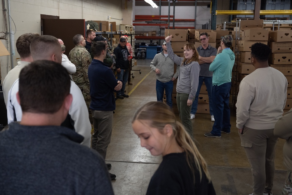 Racers and family assemble holiday baskets