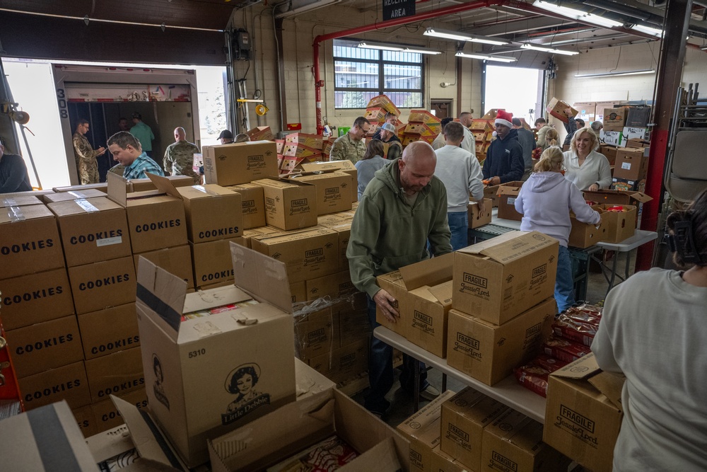 Racers and family assemble holiday baskets
