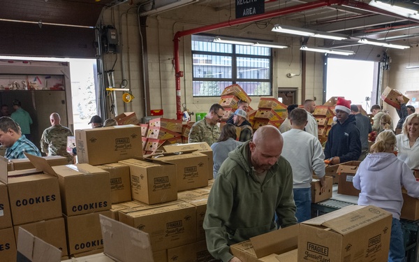Racers and family assemble holiday baskets