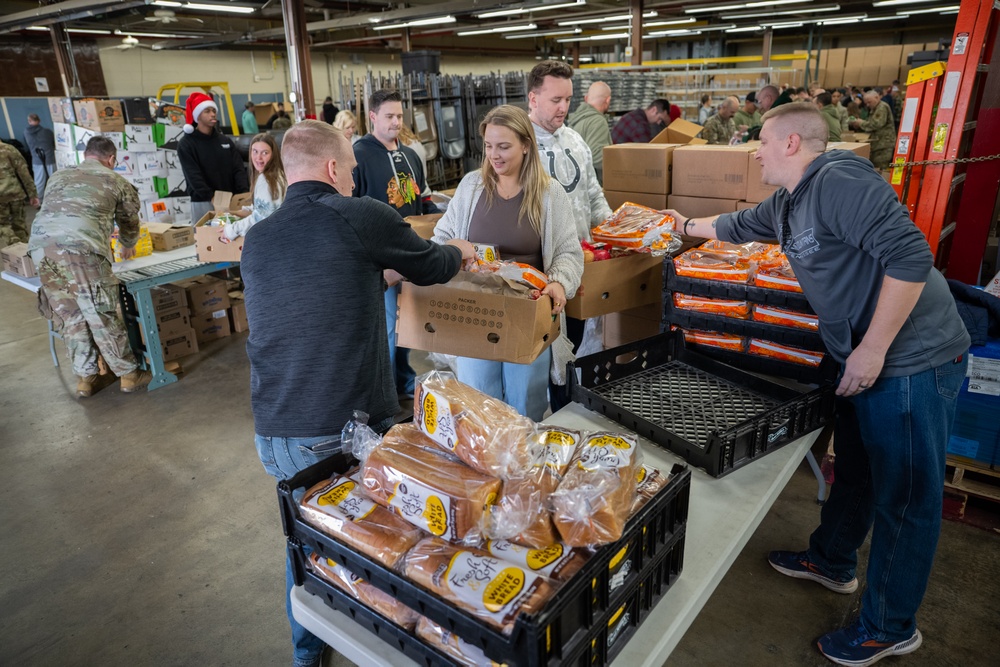 Racers and family assemble holiday baskets