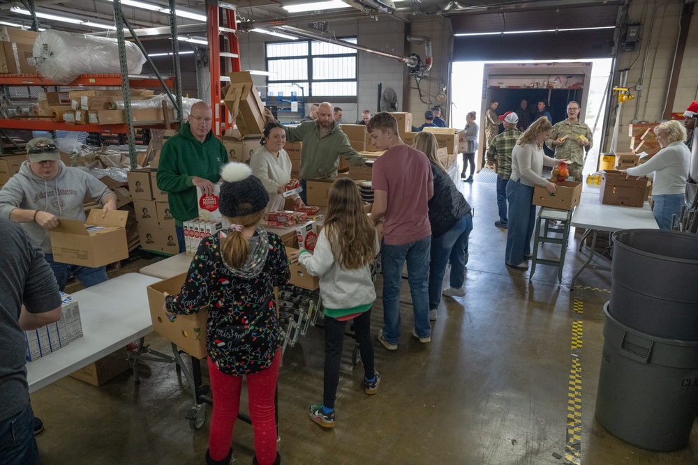 Racers and family assemble holiday baskets