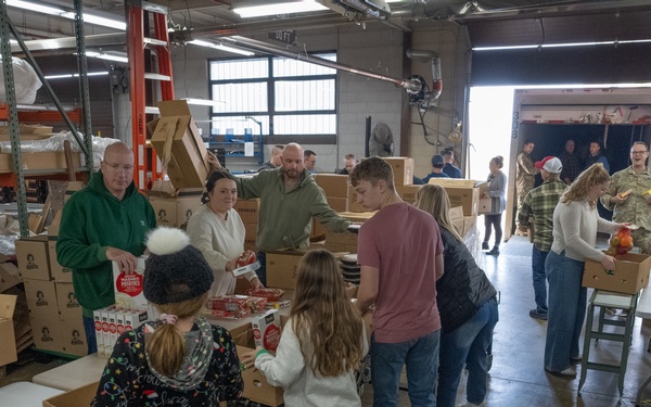 Racers and family assemble holiday baskets