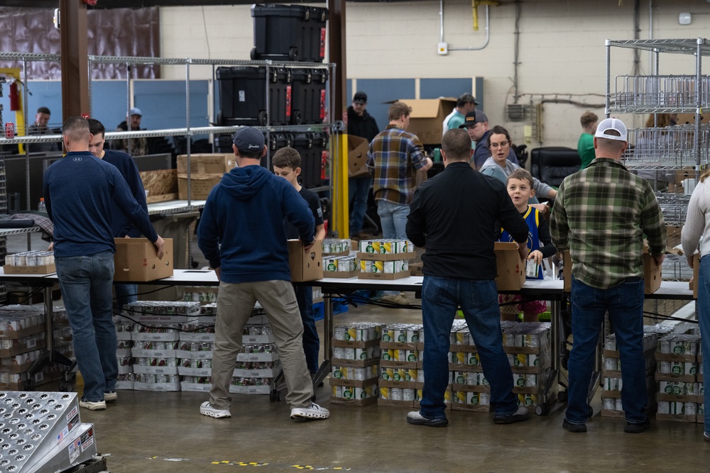 Racers and family assemble holiday baskets