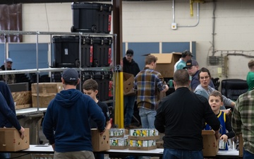 Racers and family assemble holiday baskets