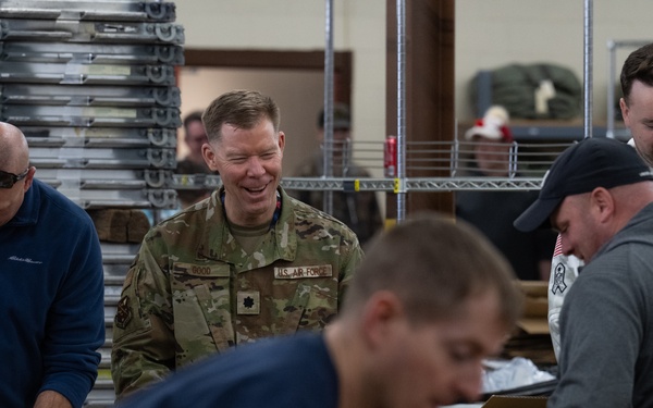 Racers and family assemble holiday baskets