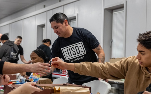 Soldiers in Latvia decorate gingerbread cookies at USO Christmas event
