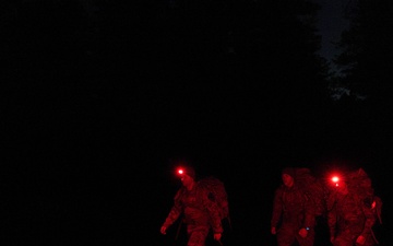 Best By Test participants navigate the night on a ruck