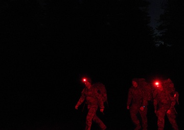 Best By Test participants navigate the night on a ruck