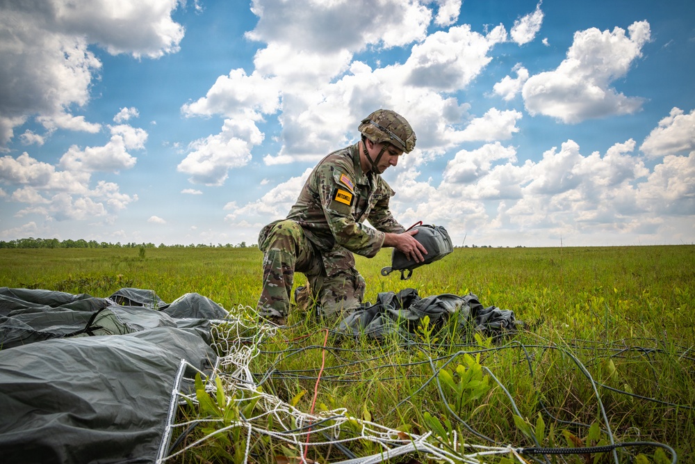 Soldier loading his parachute after jumping from a UH-60