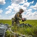 Soldier loading his parachute after jumping from a UH-60