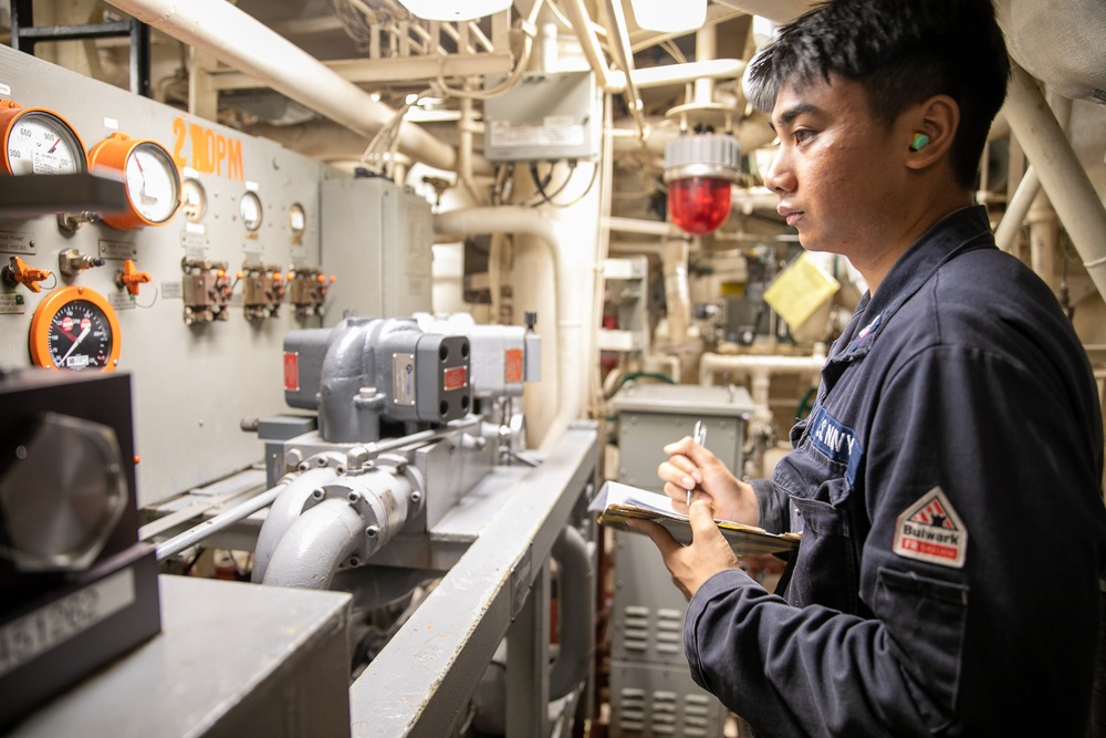 USS Mitscher (DDG 57) Sailor logs readings in main machinery room one