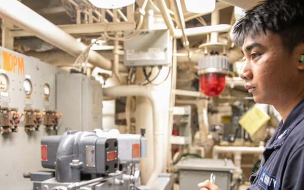 USS Mitscher (DDG 57) Sailor logs readings in main machinery room one