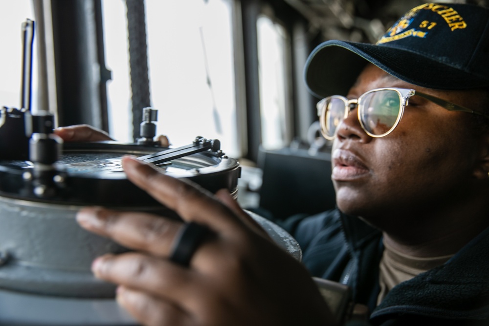 USS Mitscher (DDG 57) junior officer stands watch in ship bridge