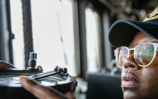 USS Mitscher (DDG 57) junior officer stands watch in ship bridge