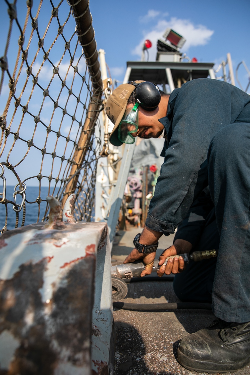 USS Mitscher (DDG 57) Sailor conducts flight deck preservation