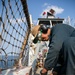 USS Mitscher (DDG 57) Sailor conducts flight deck preservation