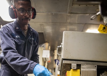 USS Mitscher (DDG 57) Sailor conducts preventative maintenance in compost disposal room