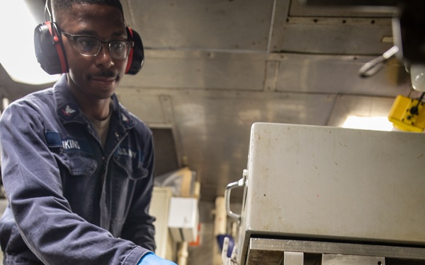 USS Mitscher (DDG 57) Sailor conducts preventative maintenance in compost disposal room