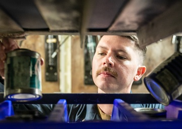 USS Mitscher (DDG 57 Sailor takes inventory in ship HAZMAT storeroom