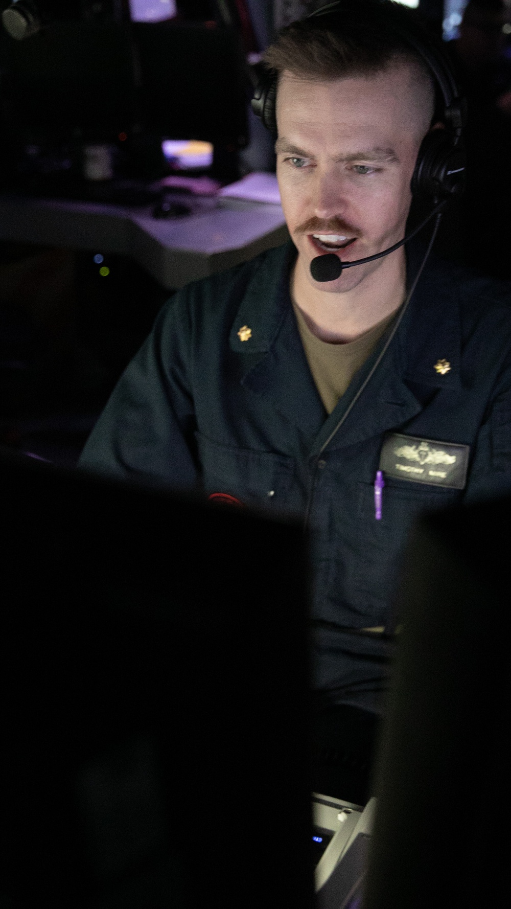 USS Mitscher (DDG 57) officer stands TAO watch in ship CIC