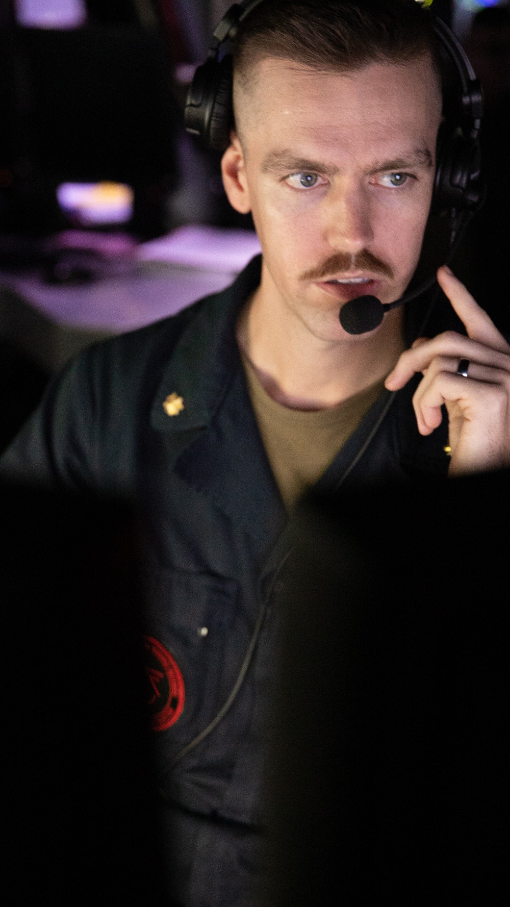 USS Mitscher (DDG 57) officer stands TAO watch in ship CIC