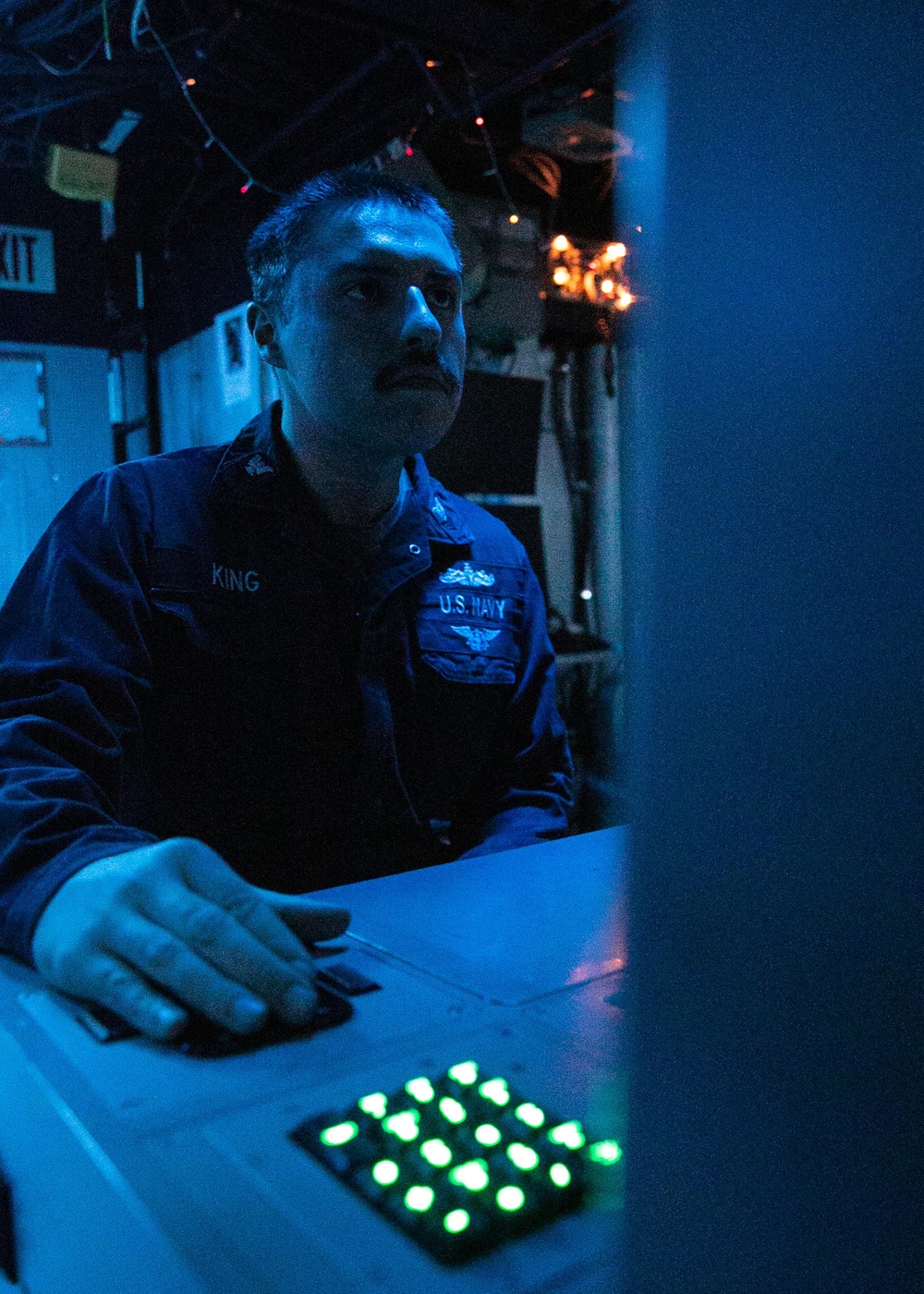 USS Mitscher (DDG 57) Sailor stands watch in sonar control room
