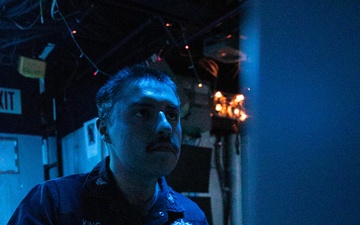 USS Mitscher (DDG 57) Sailor stands watch in sonar control room