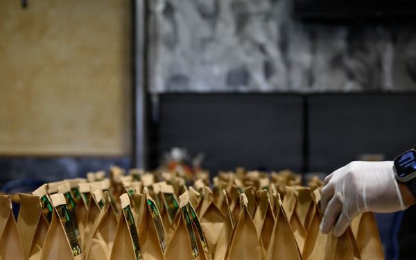 Spangdahlem Air Base volunteers fill over 450 bags of cookies to give to Airmen