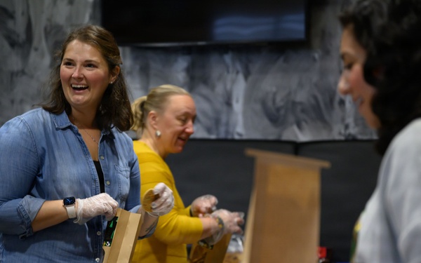 Spangdahlem Air Base volunteers fill over 450 bags of cookies to give to Airmen
