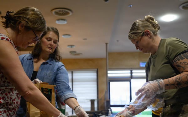 Spangdahlem Air Base volunteers fill over 450 bags of cookies to give to Airmen