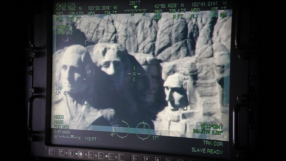 U.S. Coast Guard aircraft soar over Mount Rushmore