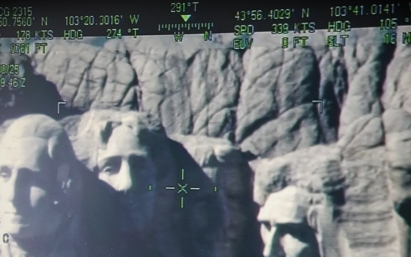 U.S. Coast Guard aircraft soar over Mount Rushmore