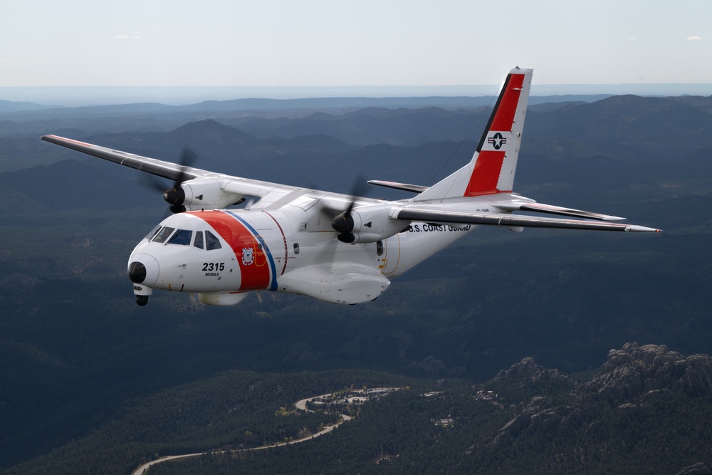 U.S. Coast Guard aircraft soar over Mount Rushmore